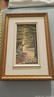 Full view of framed painting showing the forest path and bird in flight.
