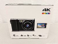 Box showing the camera image and key specs: 24.0 MP, 4K, 4.0-inch HD screen, 8x super zoom, continuous shooting.