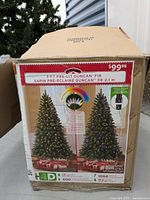 Box of 7-foot Pre-Lit Duncan Fir Christmas Tree showing packaging and product information including light count and tree dimensions.