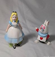 Front view of Alice and White Rabbit ceramic figures showing clothing and facial details.