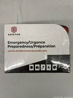 Photo of the Safetron branded sealed Emergency Preparedness and First Aid kit box showing front details and emergency symbols.
