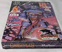 Front angle of sealed box showing gargoyle artwork and branding