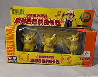Front view of the original Japanese release Tomy Pocket Monster box containing 3 Pikachu figures showing the color and graphics of the packaging and figures inside.