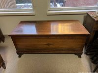 Exterior front and top view showing wood finish and inlay