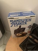 Decosonic sandwich maker in original box showing front of the packaging with sandwich illustration.