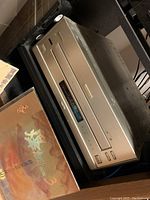 Three-quarter angled view of champagne silver front-loading player on shelf