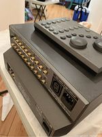 Side view of stacked preamp and CD player showing RCA input/output jacks and IEC power connectors