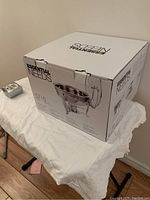 Photo of the sealed original packaging box labeled Essential Needs 57/8 chafing dish