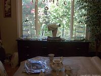 Full frontal shot of the dark wooden dining room display stand with glass top, three drawers, and two side compartments.