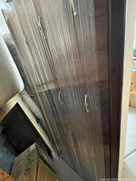 Photo showing the side drawers in original wrapper, angled view highlighting the shiny finish and drawer handles.