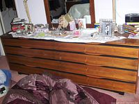 Front view of six-drawer wooden dresser with matching rectangular mirror and wood-grain veneer finish.