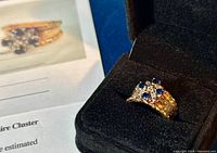 Ring set in black jewelry box with partial view of appraisal document