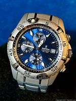 Close-up of the Festina men's chronograph wristwatch showing blue dial, three subdials, date window, and steel case and bracelet.