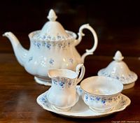 Front view of the Royal Albert Memory Lane teapot with lid, creamer, sugar bowl on under-plate.