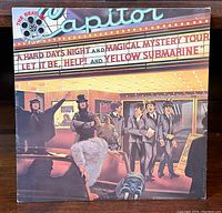 Front of the "Reel Music" LP sleeve showing Beatles under Capitol marquee