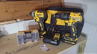 Overall set including drill driver, impact driver, charger, one battery, bit case, and canvas tool bag