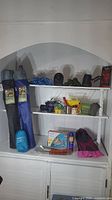 Full overview photo of all camping chairs, ropes, flippers, and various camping accessories arranged on shelves.