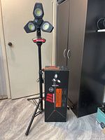 Full tripod work light standing assembled with box beside it