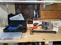 Overall view of the lot including Jobmate rotary tool in case, Black & Decker sander box, Mastercraft hammer, and drywall anchors.