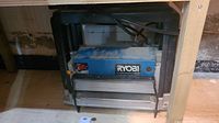 Front and side view of Ryobi planer under bench