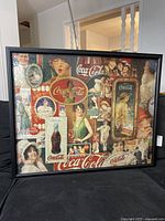 Full front view of framed Coca Cola puzzle showing vintage style collage with various people and Coca Cola branding.