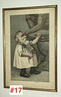 Full framed print in gold frame, showing the caricature of a small bearded man carving a sculpture's leg with hammer and chisel.