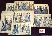 Seven antique Victorian fashion prints arranged together on a dark surface, showing multiple women in period dresses with different colors and styles.