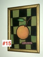Full view of framed pastel and charcoal artwork showing an orange on black and green checkerboard background with signature.