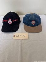 Two Howdy Doody baseball hats side by side, showing front embroidery and condition.