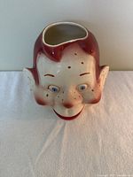 Front view of the Howdy Doody head-shaped ceramic cookie jar with detailed facial features showing freckles, blue eyes, and smiling mouth.