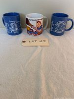 Front view of three Howdy Doody mugs with lot number card in front