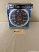Boxed Acurite Designer Edition Howdy Doody Thermometer, white framed, black dial with character, sealed in original packaging.
