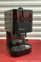 Front angled view showing control buttons, drip tray, and water reservoir on the side