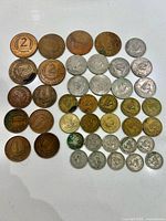 Top-down photo of 38 assorted British Caribbean Territories coins including 2 cents, nickels, quarters and pennies arranged in rows showing obverse and reverse sides.