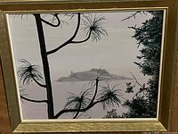 Front view of framed oil painting showing pine branches and island landscape