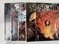Five vintage Spawn comic books laid out vertically with visible covers and issue numbers 85, 87, 88, 91, 92. Shows the front covers in protective sleeves.