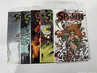 Five Spawn comic books issues 93-97 in protective sleeves, front cover showing detailed colorful artwork.
