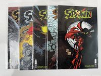 Five Spawn comic books displayed side by side, showing cover art and numbers 98, 99, 102, 103, and 106.