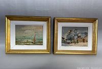 Photo of two small framed original paintings on board, showing seascape and snowy village scenes.