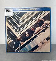 Front cover photo of The Beatles 1967-1970 blue vinyl record showing the band members looking down from a stairwell.