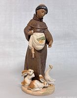 Front angle of Lladró Farmyard Grace figurine showing monk and animals