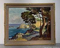 Frontal view of framed coastal landscape painting showing carved gilt frame