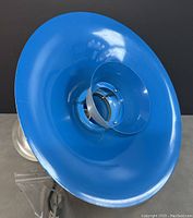Blue metal wide reflector shade of the ceiling pendant light showing the concave interior and the bulb holder
