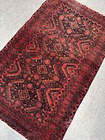 Full view of vintage hand woven wool rug showcasing overall pattern and condition