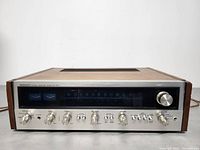 Front view of aluminum faceplate showing tuning dial, VU meters and control knobs