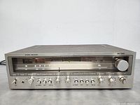 Front view of the Zenith MC 7030 stereo receiver showing tuning display and control knobs.