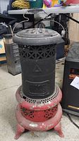 Vintage Perfection oil heater with visible wear on paint and surface, showing top handle and ventilation pattern