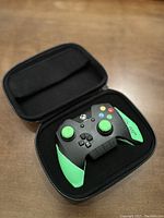 Razer Wildcat wired Xbox One controller inside open carrying case showing green thumbsticks and grips