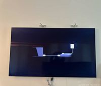 TV mounted on wall displaying connection graphic on-screen