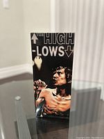 Front view of the box with image of shirtless Hiroto Komoto holding microphone, with band name The High Lows prominently displayed.